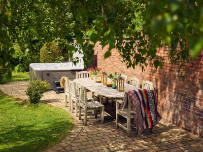 Curlew Cottage: Patio with garden furniture & hot tub