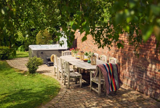Curlew Cottage: Patio with garden furniture & hot tub