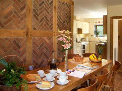 Curlew Cottage: Oak beamed dining area & kitchen beyond