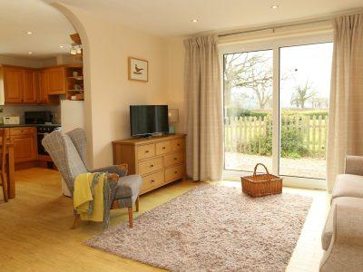 Pheasant Walk: Sitting room with kitchen beyond