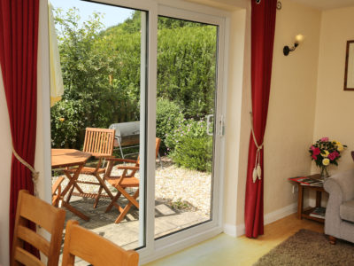 Woodpecker Way: French doors from sitting room out to sunny enclosed patio
