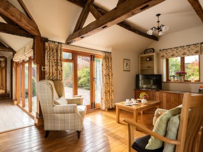 Garden Cottage: Oak beamed sitting room with French doors to courtyard