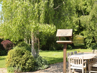 Curlew Cottage: Patio area with large flat lawned area beyond